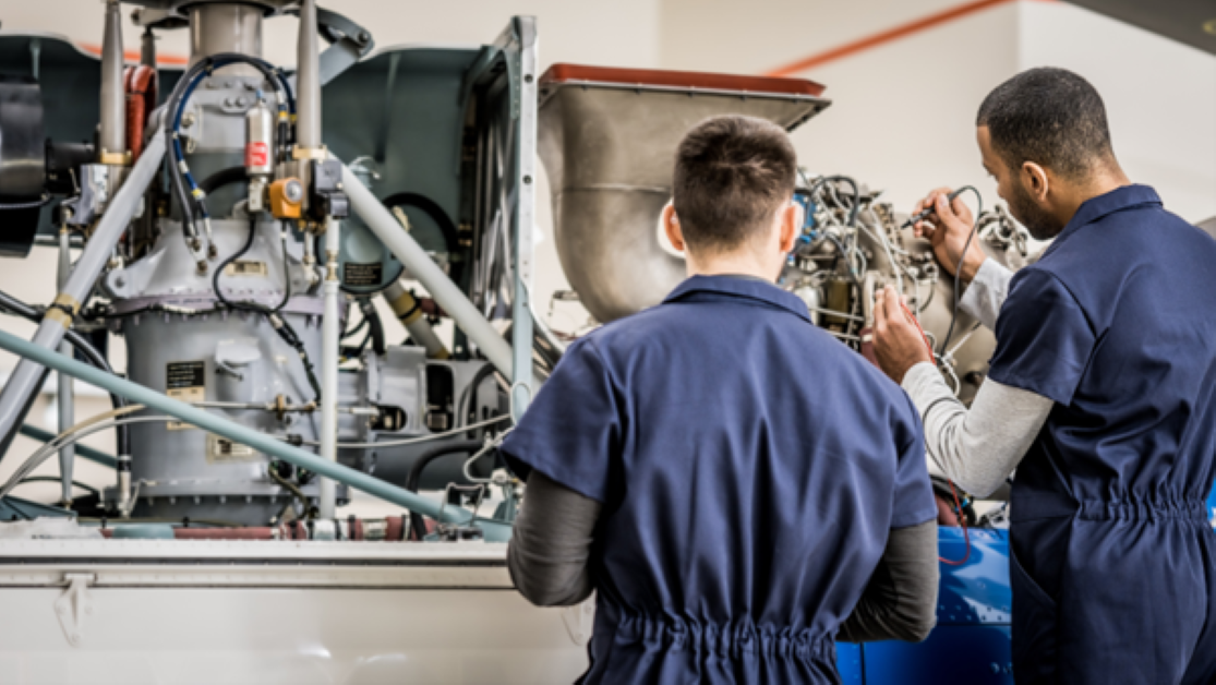 Engineers looking at an engine